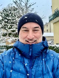 Portrait of man standing outdoors during winter