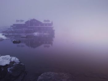 Reflection of sky on water in foggy weather