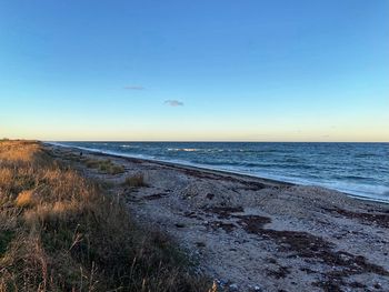 Scenic view of sea against clear sky during sunset