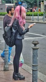 Full length of woman standing on wall