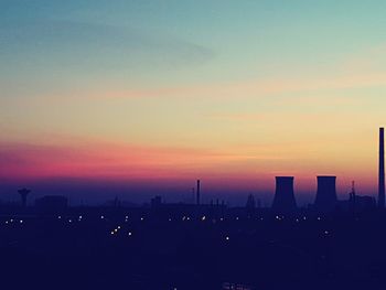 Silhouette cityscape against sky during sunset