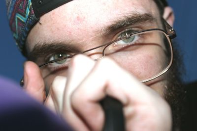 Close-up portrait of young man wearing eyeglasses