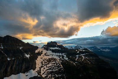 Scenic view of snowcapped mountains against sky during sunset