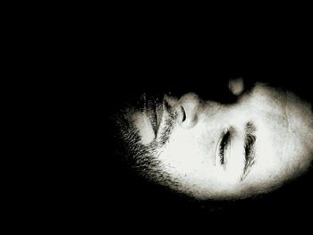 Close-up of human hand against black background