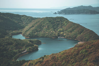 High angle view of sea and mountains against sky