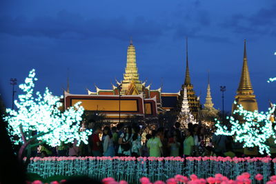 Illuminated traditional building against sky