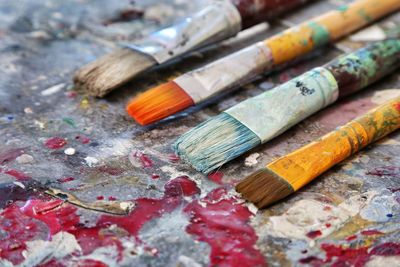 Close-up of paintbrushes on dirty table