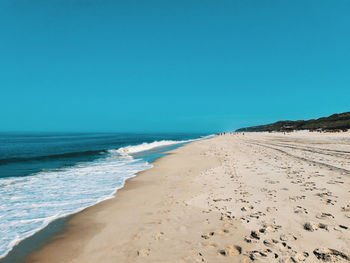 Scenic view of beach against clear sky