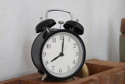 Close-up of clock on table at home