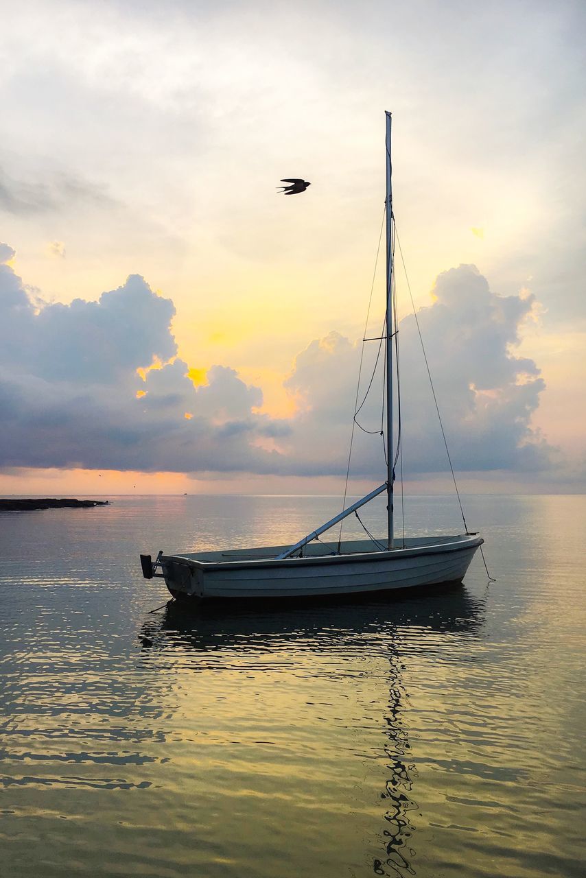 nautical vessel, water, transportation, sky, mode of transportation, sunset, cloud - sky, waterfront, sea, beauty in nature, scenics - nature, nature, sailboat, reflection, no people, orange color, tranquility, non-urban scene, idyllic, outdoors