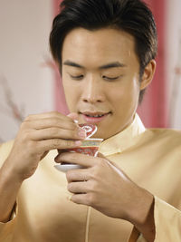 Man holding drink while at home during festival