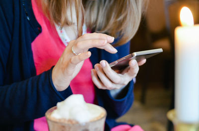 Midsection of woman hand using phone