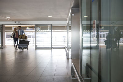 People walking in corridor of building