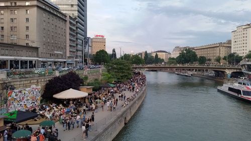 Panoramic view of people in city against sky