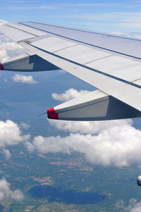 Cropped image of airplane wing against sky