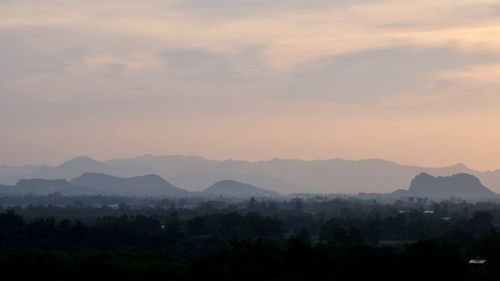 Scenic view of silhouette mountains against sky at sunset