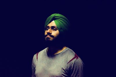 Man in turban against black background