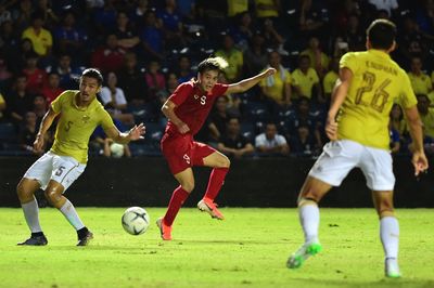 Group of people playing soccer on field