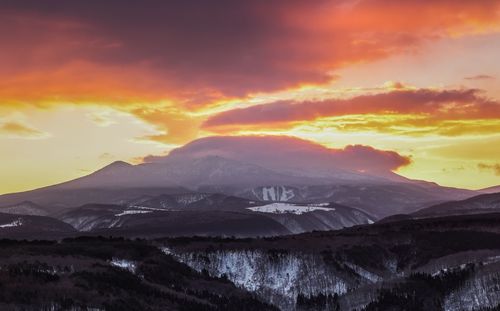 Scenic view of snow covered mountains against sky