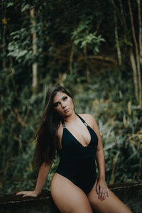 Portrait of beautiful young woman lying on land