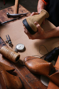 High angle view of man making shoes