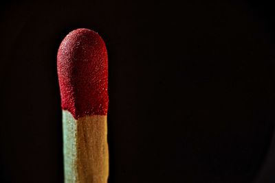 Close-up of red umbrella against black background