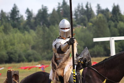 Man riding horse on field