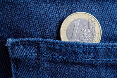 Close-up of coin in back pocket of jeans