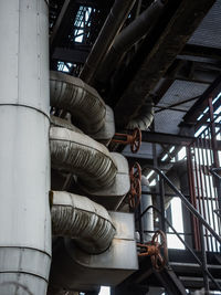 Low angle view of pipes and valves at industry