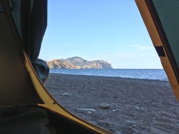 Scenic view of sea seen through tent