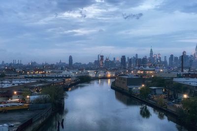 High angle view of river amidst buildings against sky
