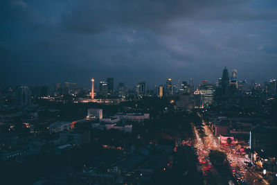 High angle view of illuminated buildings in city at night