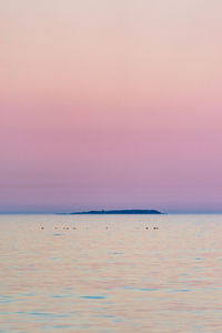 Scenic view of sea against romantic sky at sunset