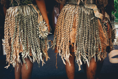 Midsection of people standing on traditional clothing