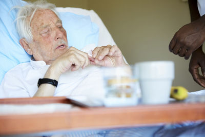 Midsection of man and woman sitting on table