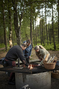 Rear view of man sitting in forest