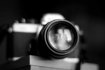 Close-up of camera lens against blurred background