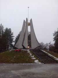 View of footpath in park against clear sky