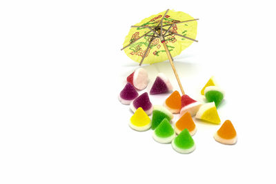 Close-up of multi colored candies against white background