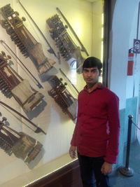 Portrait of young man standing in store