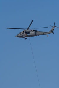 Low angle view of airplane against clear blue sky