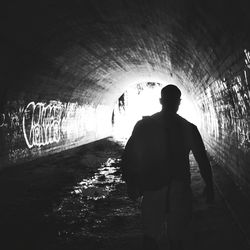 Woman standing in tunnel