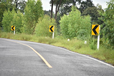 Road sign by trees