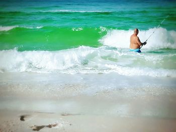 Full length of shirtless man in sea