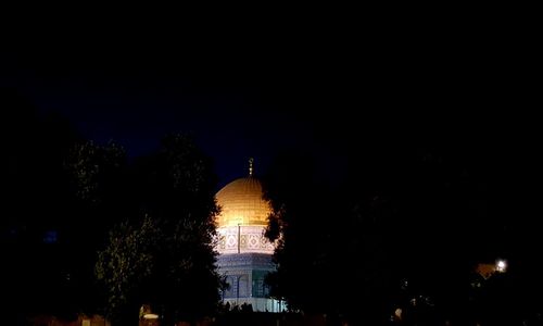 Low angle view of illuminated building against sky at night