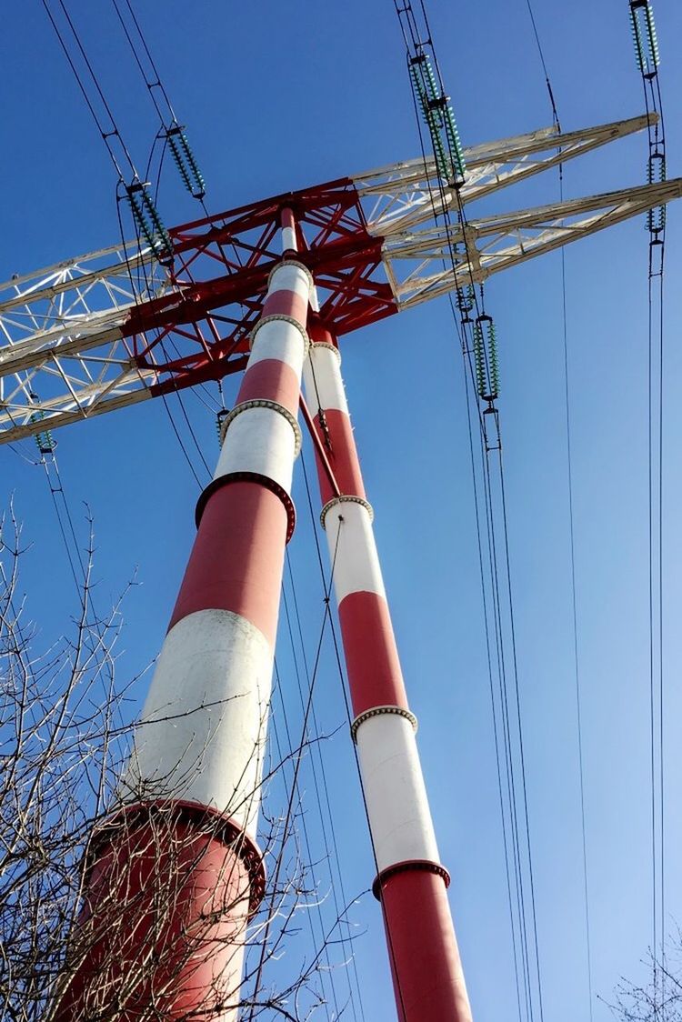 low angle view, cable, day, blue, power line, fuel and power generation, industry, clear sky, sunlight, outdoors, technology, sky, no people, electricity pylon