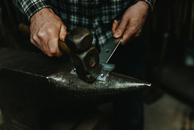 Midsection of man working on barbecue grill