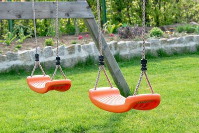 Close-up of swing hanging on playground