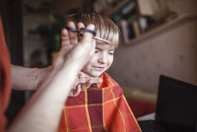 Portrait of woman holding mobile phone at home