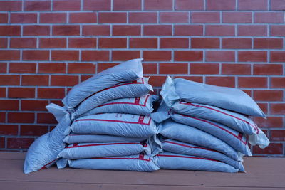 Close-up of clothes tied on brick wall